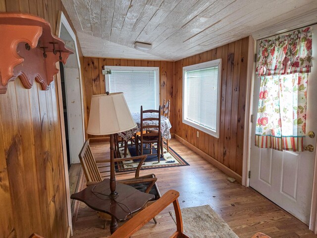 291 Pea Ridge Rd, Chester, ME 04457 - dining space with light wood-type flooring, wooden ceiling, and wood walls