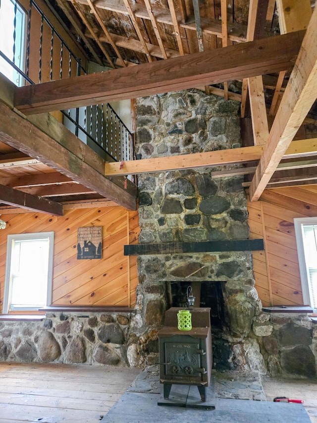 291 Pea Ridge Rd, Chester, ME 04457 - detailed view of a wood stove, wood walls, beamed ceiling, and wood finished floors