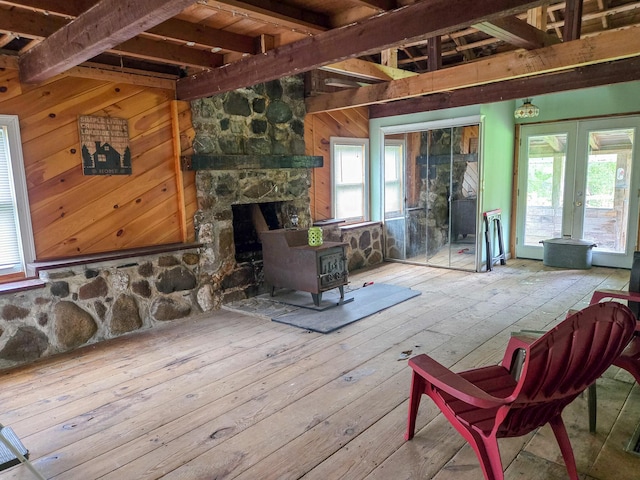 291 Pea Ridge Rd, Chester, ME 04457 - living area with a wood stove, hardwood / wood-style flooring, french doors, beamed ceiling, and wood walls