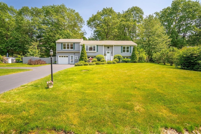 30 Date St, Old Orchard Beach, ME 04064 - bi-level home with asphalt driveway, a garage, and view of wooded area