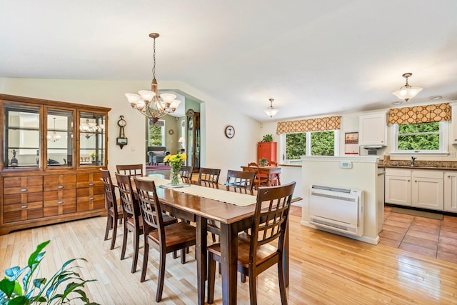 30 Date St, Old Orchard Beach, ME 04064 - dining room with light wood finished floors, a chandelier, lofted ceiling, and heating unit