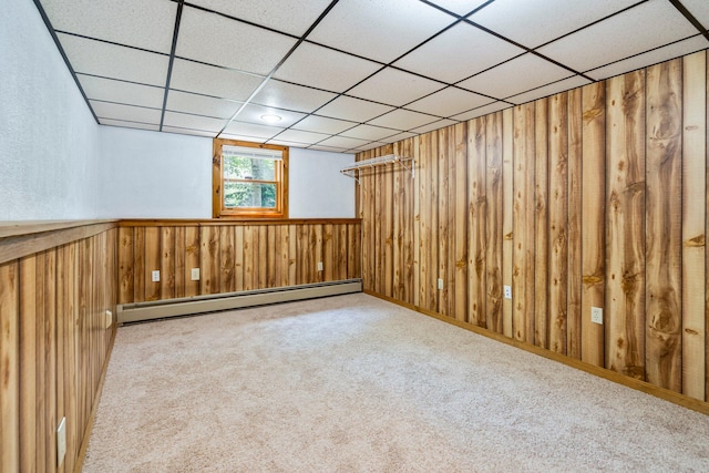 30 Date St, Old Orchard Beach, ME 04064 - below grade area with a baseboard heating unit, wood walls, a drop ceiling, carpet, and wainscoting