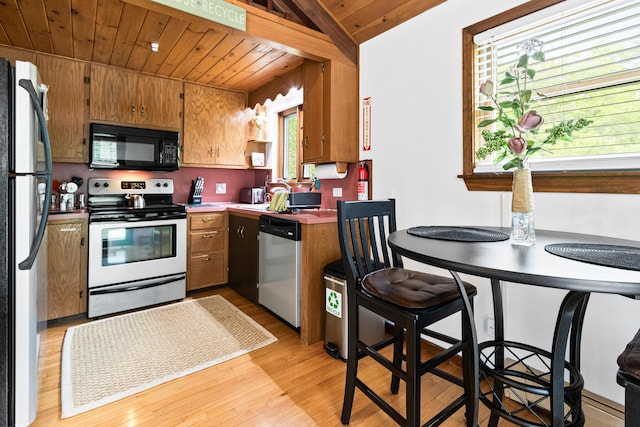 2 Flynn Rd, Raymond, ME 04071 - kitchen featuring appliances with stainless steel finishes, wood ceiling, light wood finished floors, brown cabinetry, and lofted ceiling