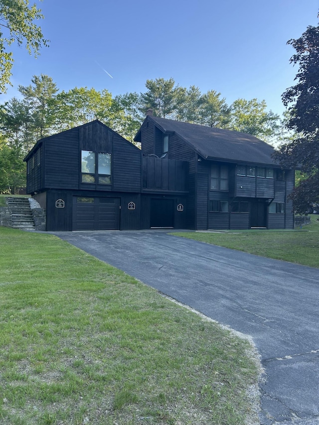 2 Flynn Rd, Raymond, ME 04071 - view of front of house with driveway, a garage, a front lawn, and a chimney