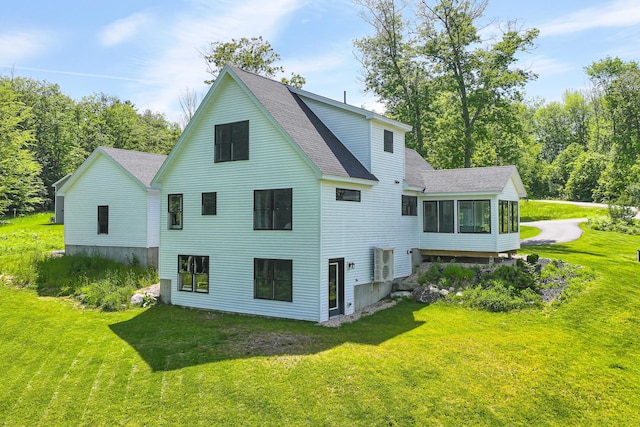 7 Elysian Way, Bridgton, ME 04009 - back of property with a sunroom, roof with shingles, and a yard