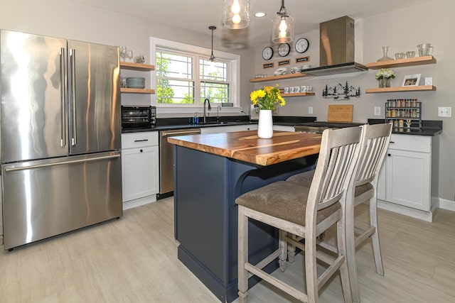 7 Elysian Way, Bridgton, ME 04009 - kitchen with open shelves, stainless steel appliances, butcher block countertops, island range hood, and a kitchen island
