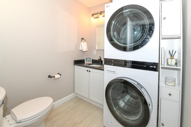 7 Elysian Way, Bridgton, ME 04009 - laundry area with stacked washing machine and dryer, light wood-style flooring, and baseboards