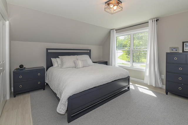 7 Elysian Way, Bridgton, ME 04009 - bedroom with lofted ceiling, baseboards, and light wood-style flooring