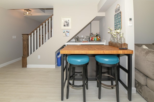 7 Elysian Way, Bridgton, ME 04009 - indoor dry bar with light wood finished floors, stairway, and baseboards
