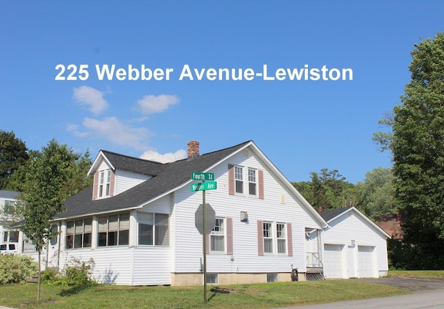 225 Webber Ave, Lewiston, ME 04240 - view of front of property with a chimney, an outbuilding, roof with shingles, and a detached garage