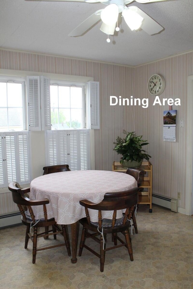 225 Webber Ave, Lewiston, ME 04240 - dining space with wallpapered walls, ceiling fan, and a baseboard heating unit