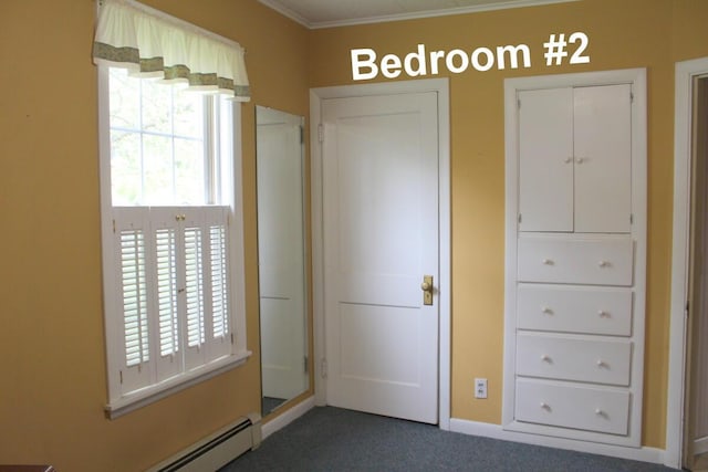 225 Webber Ave, Lewiston, ME 04240 - unfurnished bedroom featuring a baseboard heating unit, dark colored carpet, and ornamental molding