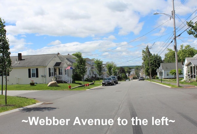 225 Webber Ave, Lewiston, ME 04240 - view of asphalt road with street lights, a residential view, and curbs