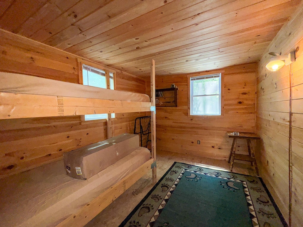 71 Wilderness Way, Burlington, ME 04417 - unfurnished bedroom with wooden walls and wooden ceiling