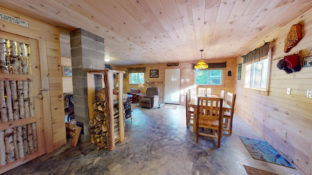 168 W Tucker Ridge Rd, Springfield, ME 04487 - dining area featuring concrete flooring, wooden walls, healthy amount of natural light, and wood ceiling
