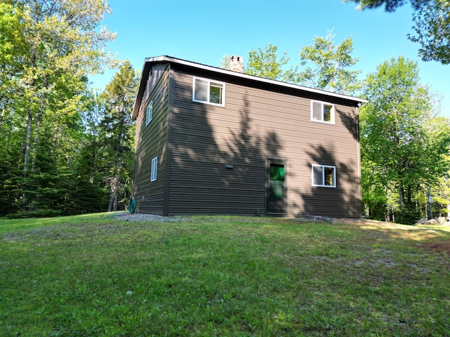 168 W Tucker Ridge Rd, Springfield, ME 04487 - view of side of home with a chimney and a lawn