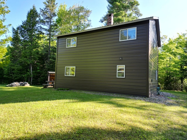 168 W Tucker Ridge Rd, Springfield, ME 04487 - view of side of home with a chimney and a yard