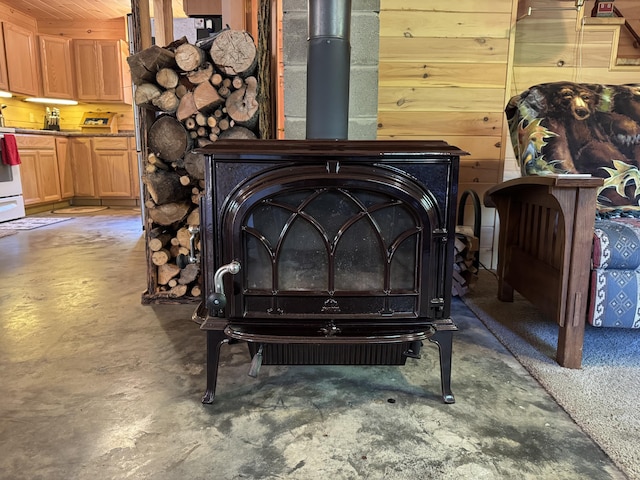 168 W Tucker Ridge Rd, Springfield, ME 04487 - detailed view of concrete floors, a wood stove, and white range oven