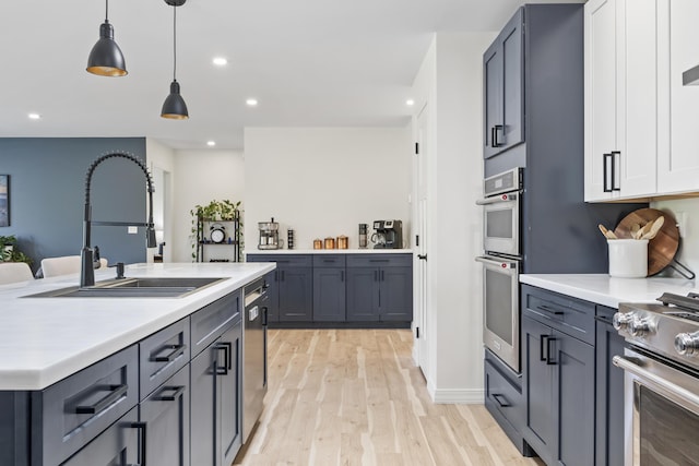 25 Royale Dr, Sidney, ME 04330 - kitchen with appliances with stainless steel finishes, a sink, light wood-type flooring, light countertops, and recessed lighting