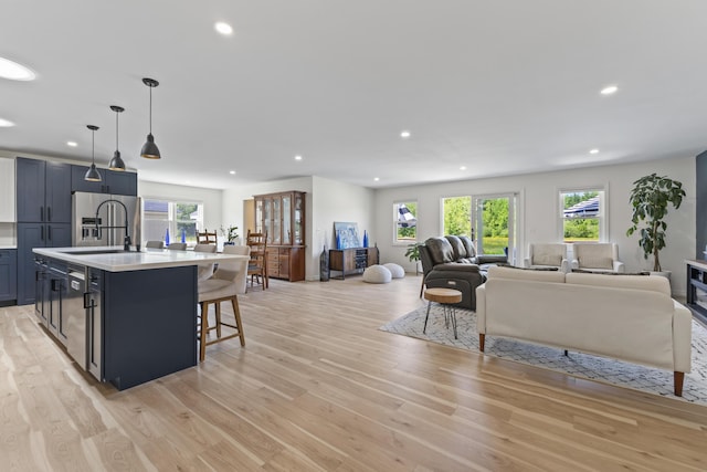 25 Royale Dr, Sidney, ME 04330 - kitchen featuring stainless steel appliances, light countertops, open floor plan, light wood finished floors, and recessed lighting