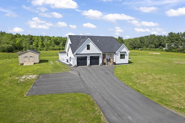 25 Royale Dr, Sidney, ME 04330 - modern farmhouse with a garage, a front lawn, asphalt driveway, board and batten siding, and a view of trees