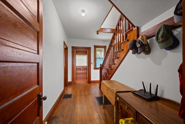 110 Depot St, Unity, ME 04988 - foyer entrance with hardwood / wood-style flooring, stairs, and baseboards