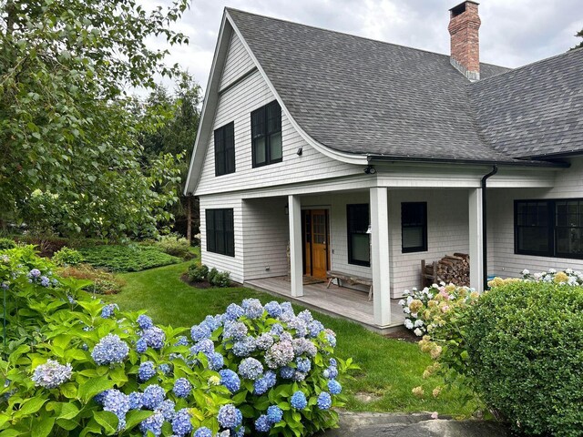 19 Vista Way, Mount Desert, ME 04660 - back of house with roof with shingles, a chimney, and covered porch