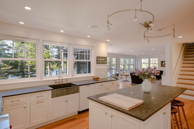 19 Vista Way, Mount Desert, ME 04660 - kitchen with light wood-type flooring, recessed lighting, white cabinets, dark stone counters, and open floor plan