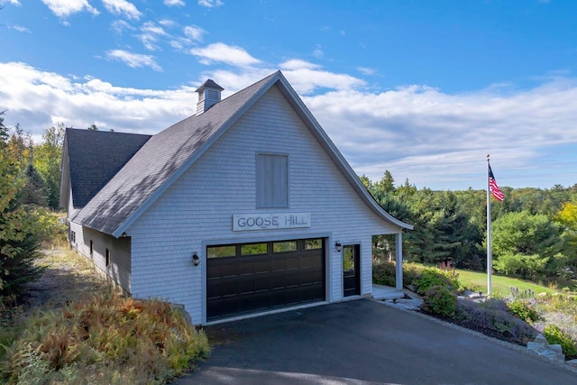 19 Vista Way, Mount Desert, ME 04660 - view of front facade with a chimney, a shingled roof, a garage, and asphalt driveway