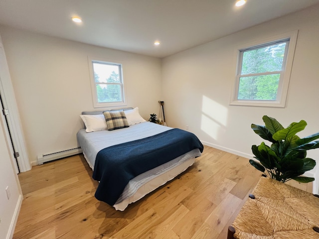 23 Ichabod Ln, Hampden, ME 04444 - bedroom with a baseboard radiator, multiple windows, recessed lighting, baseboards, and light wood-style floors