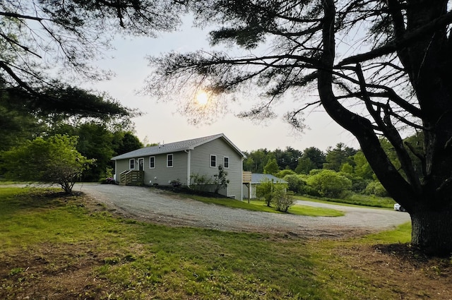 23 Ichabod Ln, Hampden, ME 04444 - view of side of home featuring driveway and a yard