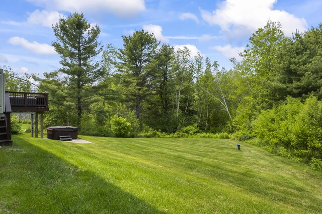 54 Tree Farm Rd, Brunswick, ME 04011 - view of green lawn featuring a hot tub, a deck, and a forest view