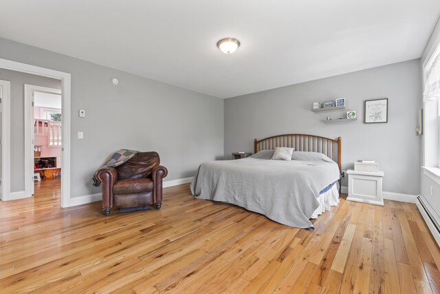 54 Tree Farm Rd, Brunswick, ME 04011 - bedroom with light wood finished floors, baseboard heating, and baseboards