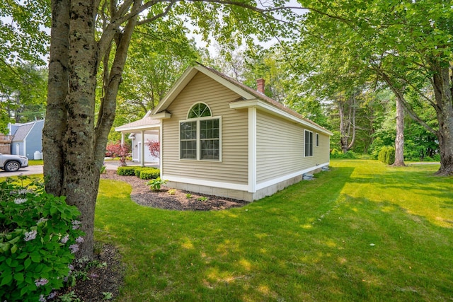 38 Shadagee Rd, Saco, ME 04072 - view of side of home featuring a chimney and a lawn