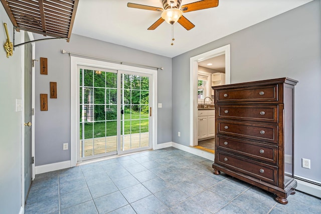 38 Shadagee Rd, Saco, ME 04072 - doorway with a ceiling fan, a sink, baseboards, tile patterned floors, and a baseboard radiator
