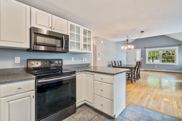 38 Shadagee Rd, Saco, ME 04072 - kitchen featuring stainless steel appliances, dark countertops, baseboard heating, white cabinetry, and lofted ceiling