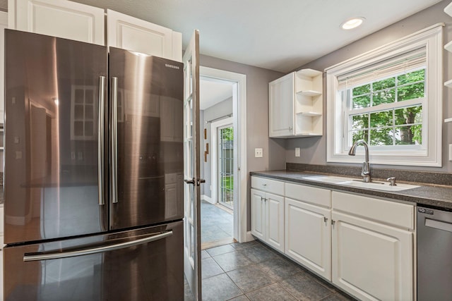 38 Shadagee Rd, Saco, ME 04072 - kitchen with stainless steel appliances, a sink, dark countertops, open shelves, and white cabinetry