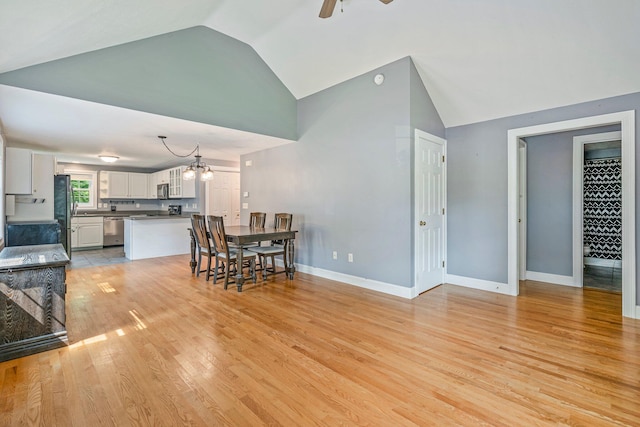 38 Shadagee Rd, Saco, ME 04072 - dining space featuring ceiling fan, light wood-style floors, high vaulted ceiling, baseboards, and a chandelier