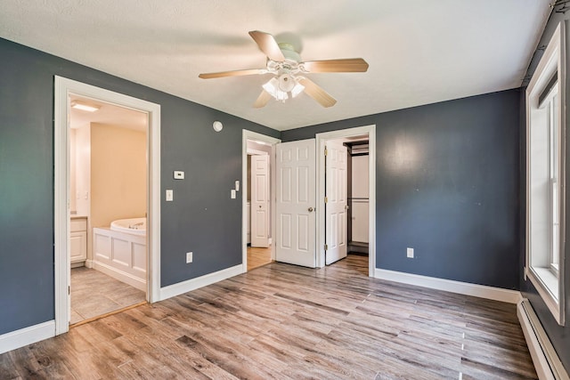 38 Shadagee Rd, Saco, ME 04072 - unfurnished bedroom with baseboard heating, baseboards, and wood finished floors