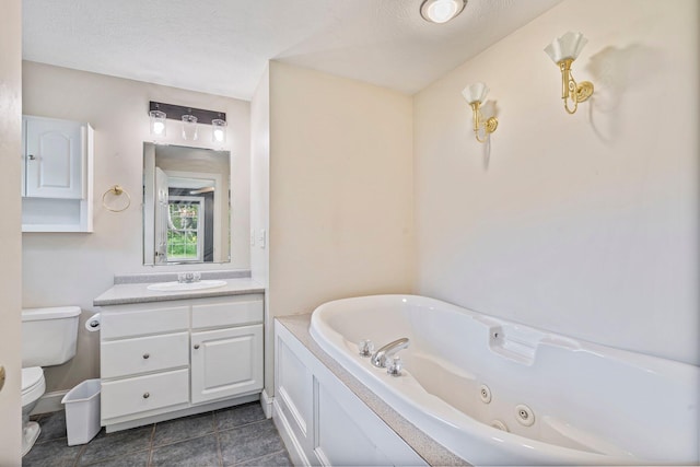 38 Shadagee Rd, Saco, ME 04072 - bathroom featuring toilet, a tub with jets, vanity, tile patterned floors, and a textured ceiling