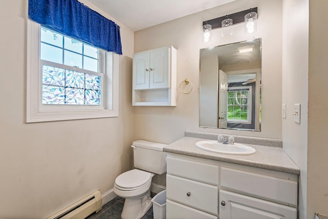 38 Shadagee Rd, Saco, ME 04072 - half bathroom featuring a baseboard heating unit, toilet, vanity, tile patterned flooring, and baseboards