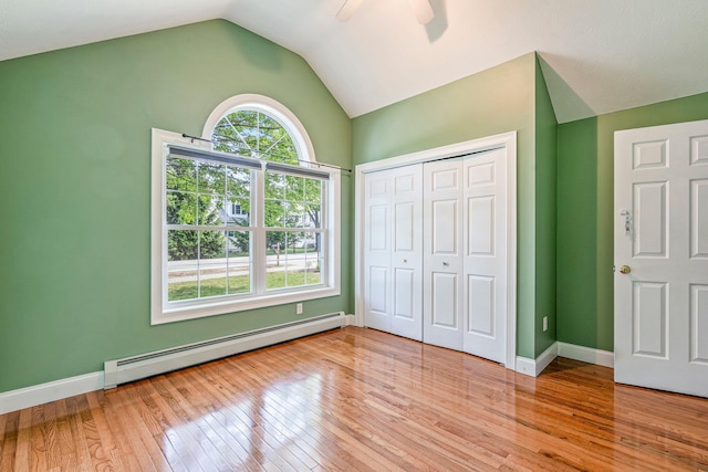 38 Shadagee Rd, Saco, ME 04072 - unfurnished bedroom featuring a baseboard radiator, lofted ceiling, light wood finished floors, a closet, and baseboards