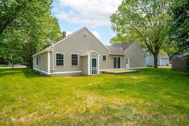 38 Shadagee Rd, Saco, ME 04072 - back of property with a chimney, a lawn, a deck, and roof with shingles