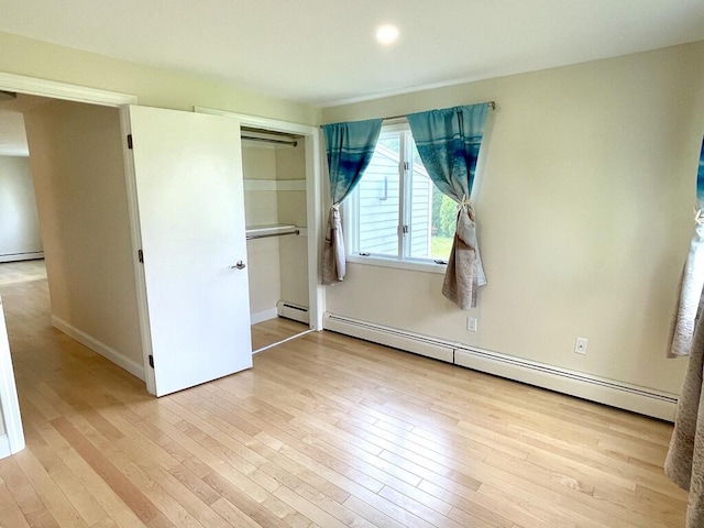 101-2 Waldo Ave Unit 3, Belfast, ME 04915 - unfurnished bedroom with baseboard heating, wood finished floors, and a closet