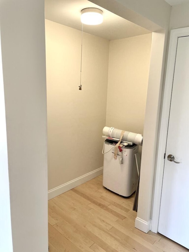 101-2 Waldo Ave Unit 3, Belfast, ME 04915 - laundry room featuring light wood-style flooring, baseboards, and water heater