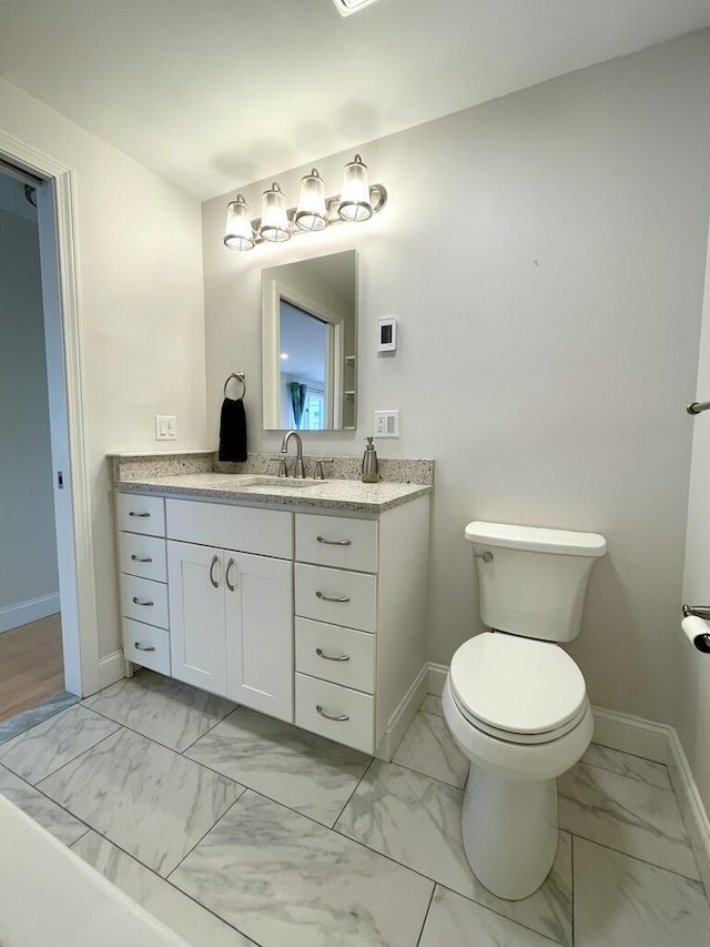 101-2 Waldo Ave Unit 3, Belfast, ME 04915 - bathroom with marble finish floors, baseboards, vanity, and toilet