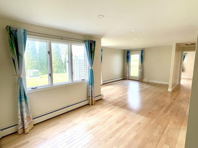 101-2 Waldo Ave Unit 3, Belfast, ME 04915 - empty room featuring baseboard heating, light wood-style flooring, healthy amount of natural light, baseboards, and recessed lighting