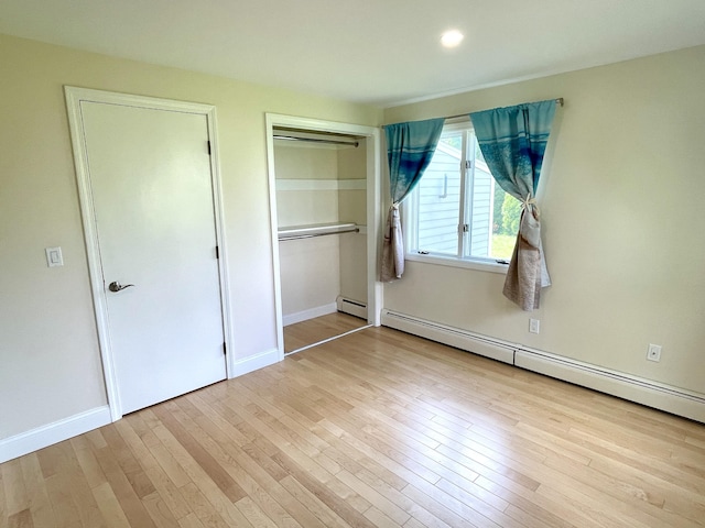 101-2 Waldo Ave Unit 3, Belfast, ME 04915 - unfurnished bedroom featuring a baseboard radiator, wood finished floors, a closet, baseboards, and recessed lighting