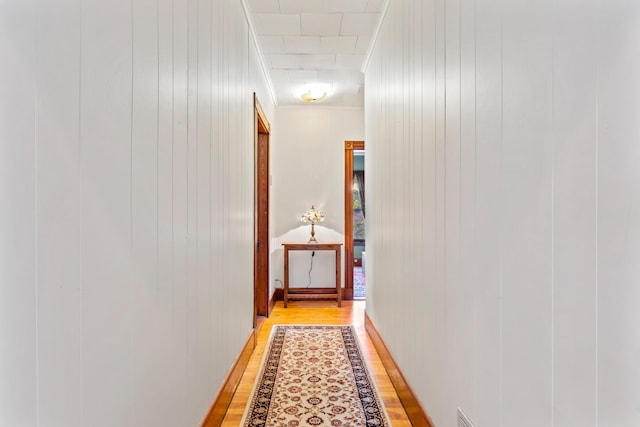 10 Hollingsworth St, Winslow, ME 04901 - corridor with light wood finished floors, ornamental molding, and wood walls