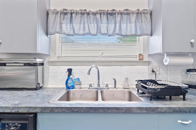 10 Hollingsworth St, Winslow, ME 04901 - kitchen view of a sink, tasteful backsplash, and dark countertops